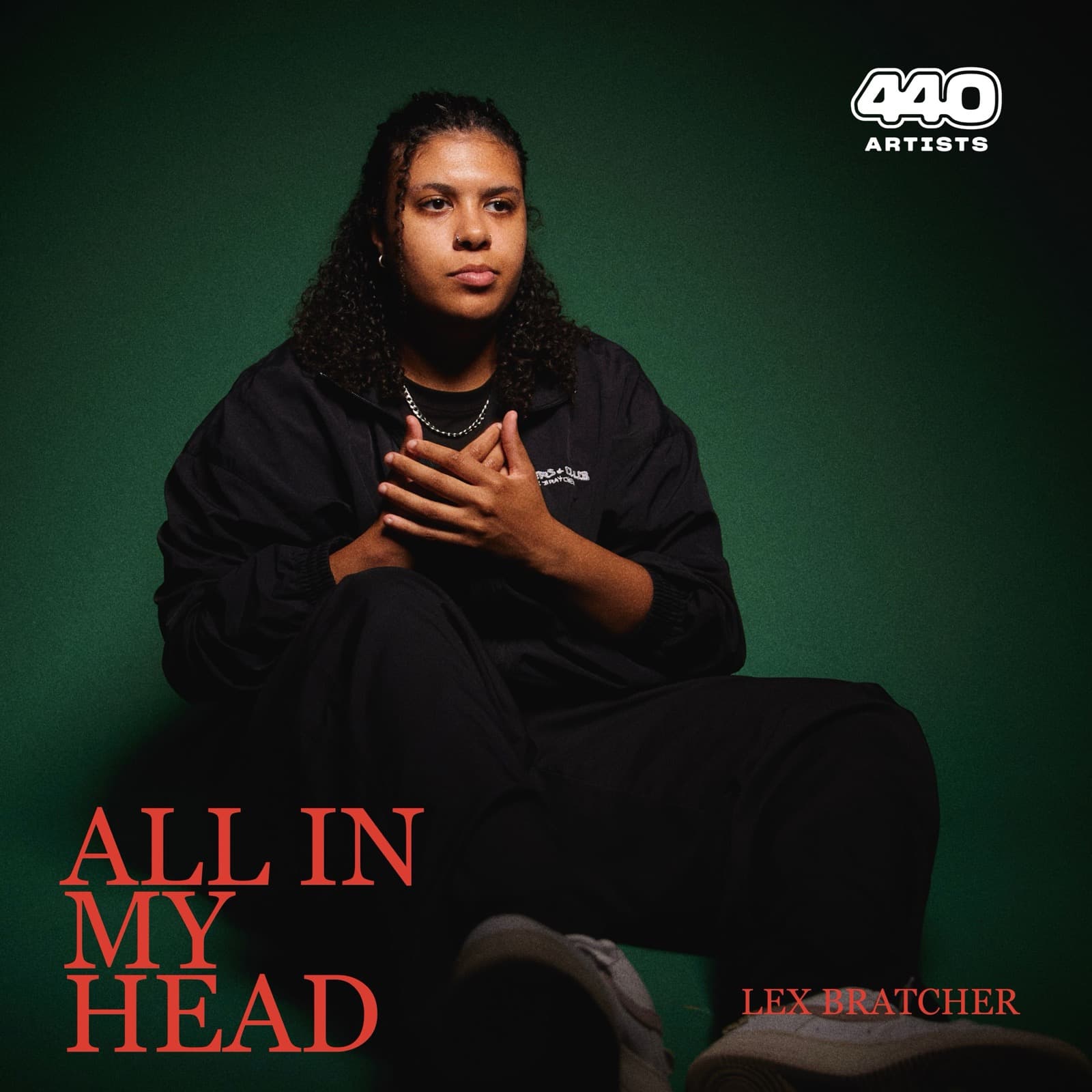All In My Head cover: Lex seated against deep green, hands folded, title in red